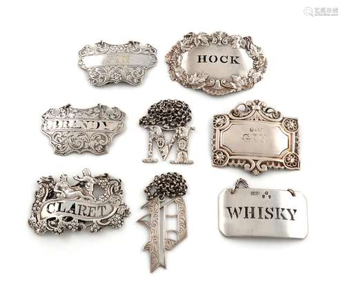 A collection of eight antique silver wine labels, comprising...