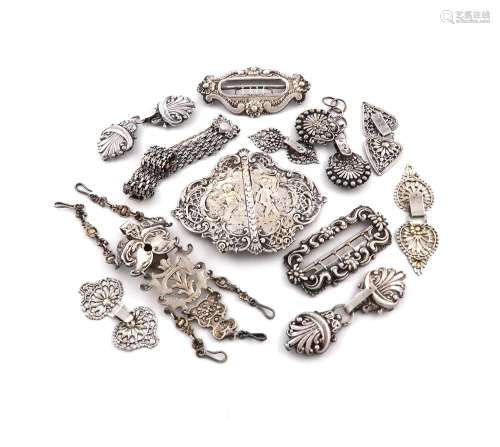 A collection of continental silver belt buckles and cloak cl...
