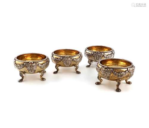 A set of four George II silver-gilt salt cellars, by Abraham...