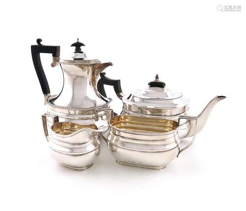 A three-piece silver tea set and a hot water pot, by William...