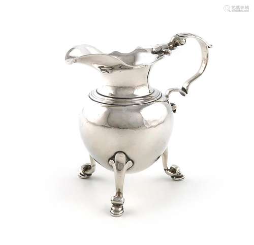 An 18th century silver cream jug, marks worn, baluster form,...