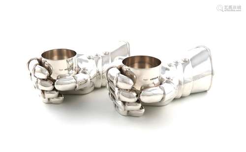 By Asprey Limited, a pair of modern novelty silver candle ho...