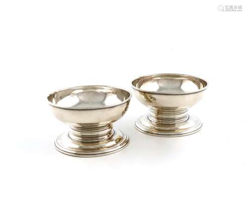 A pair of George II silver pedestal trencher salt cellars, b...