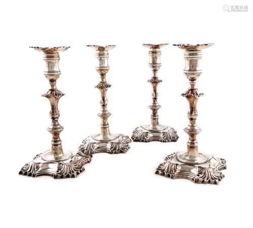 A set of four George II cast silver candlesticks, by John Ca...