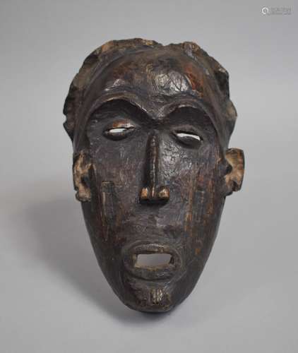 An African Carved Wooden Pan Type Tribal Mask, 25cm high