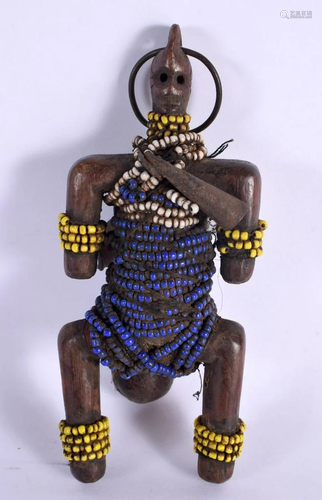 AN AFRICAN CARVED WOOD BEADED TRIBAL FIGURE. 18 cm x 8 cm.