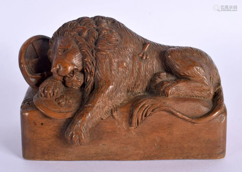 A 19TH CENTURY CARVED TREEN FIGURE OF A RECLINING LION model...