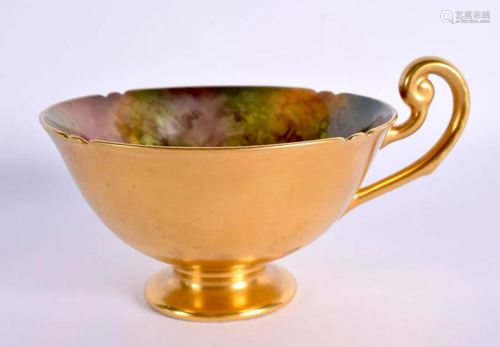 A ROYAL WORCESTER PORCELAIN CUP by H Ayrton painted with fru...