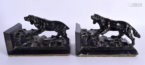 A PAIR OF EARLY 20TH CENTURY PAINTED DOGGY SPELTER BOOK ENDS...