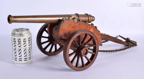 AN ANTIQUE BRONZE CANNON upon a wooden support. 55 cm x 24 c...