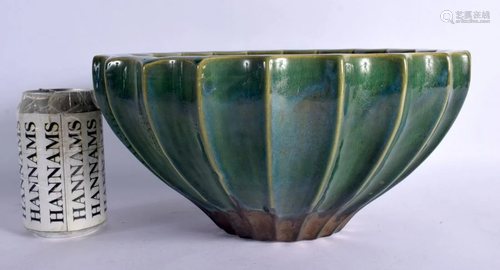 AN ARTS AND CRAFTS GREEN GLAZED POTTERY PLANTER in the manne...