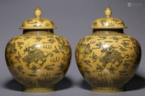 TWO CHINESE YELLOW-GROUND BLUE-AND-WHITE COVERED JARS DEPICT...