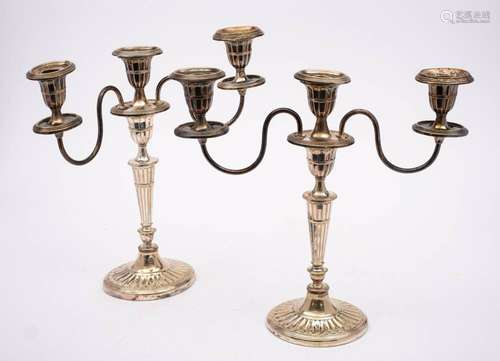 A pair of plated twin branch candelabra: with oval fluted sc...