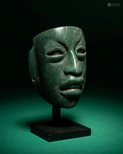 An Olmec Jade Maskette Height 3 inches (7.6 cm).