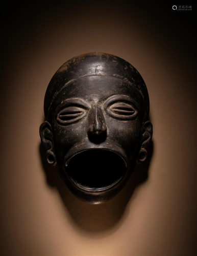 An Olmec Blackware Effigy Vessel in the Form of a Human Face...