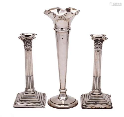 A pair of Edward VII silver Corinthian column candlesticks, ...