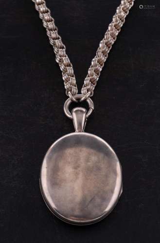 An oval locket pendant with hairwork on a fancy-link chain,:...