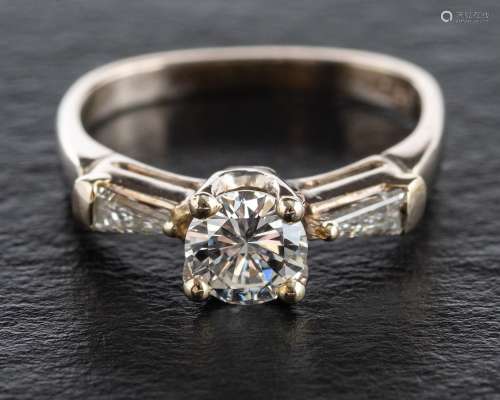 A round, brilliant and tapered baguette-cut diamond three st...