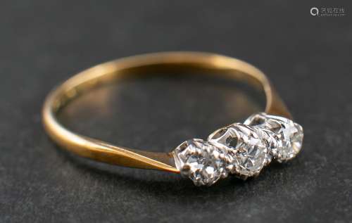 A round, brilliant-cut diamond three-stone ring,: estimated ...