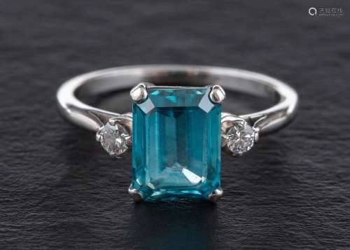 A step-cut blue topaz and round, brilliant-cut diamond three...