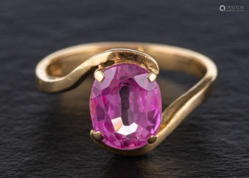 A synthetic pink sapphire ring,: stamped 750, length of ring...