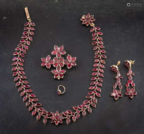 A 19th century, gold, foiled back, garnet parure of stylised...