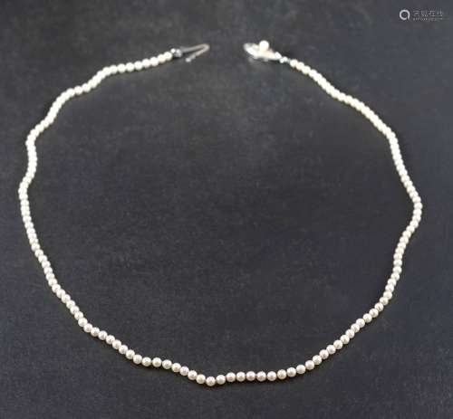 A single row necklace of Mikimoto cultured pearls to a silve...