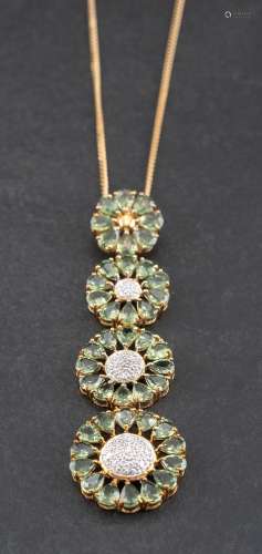 A prasolite and diamond pendant of graduated stylised flower...