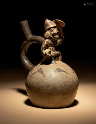 A Moche Stirup Vessel with Figure Height 9 inches (22 cm).