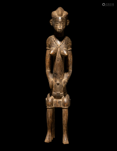 A Senufo Wood Female Figure Height 26 3/16 inches (67 cm).