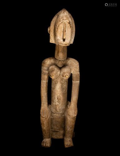 A Bamana Wood Female Figure Height 25 1/16 inches (63.8 cm).