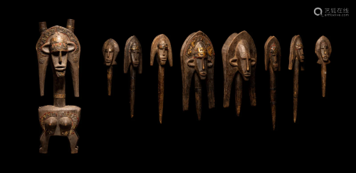 A Bamana Wood Marionette Figure with Eight Wood Puppet Heads...