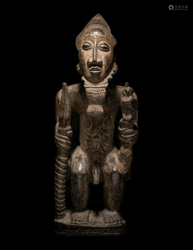 A Baule Wood Seated Male Figure Height 17.5 inches (45 cm).