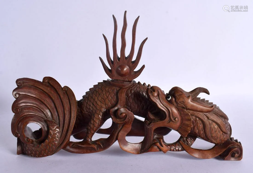 A LATE 19TH CENTURY CHINESE CARVED HARDWOOD FIGURE OF A DRAG...