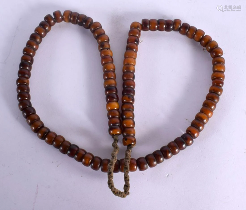 A MIDDLE EASTERN CARVED AMBER TYPE PRAYER BEAD NECKLACE. 87 ...