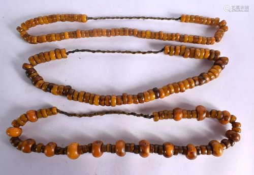 THREE LARGE MIDDLE EASTERN CARVED AMBER TYPE PRAYER NECKLACE...