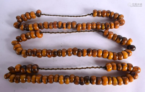 THREE LARGE MIDDLE EASTERN CARVED AMBER TYPE PRAYER NECKLACE...