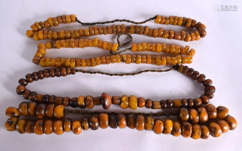 FOUR LARGE MIDDLE EASTERN CARVED AMBER TYPE PRAYER NECKLACES...