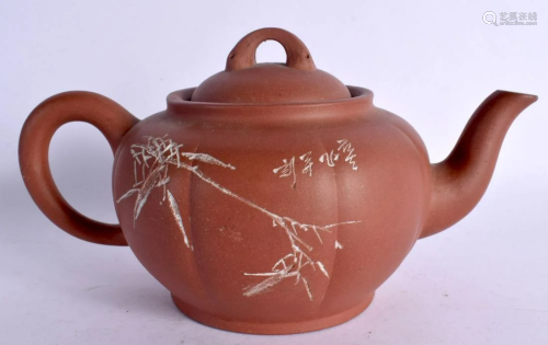 A CHINESE YIXING POTTERY TEAPOT AND COVER 20th Century. 18 c...