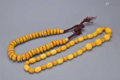 TWO AMBER COLOURED BEAD NECKLACES