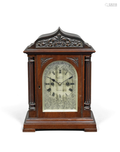 A good early 20th century carved mahogany table clock, dated...