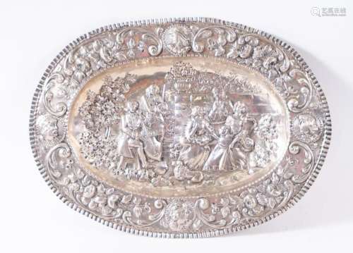 EMBOSSED SILVER TRAY REPRESENTING A MUSIC CONCERT, WITH CONT...