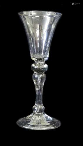 A Balustroid Wine Glass, circa 1740, the rounded funnel bowl...