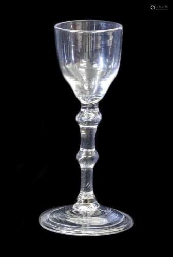 A Balustroid Wine Glass, circa 1740, the ogee bowl on a doub...