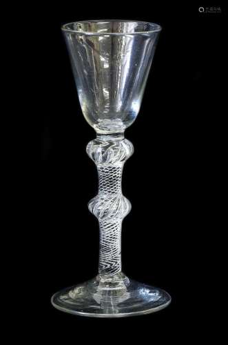 A Wine Glass, circa 1755, the rounded funnel bowl on a doubl...