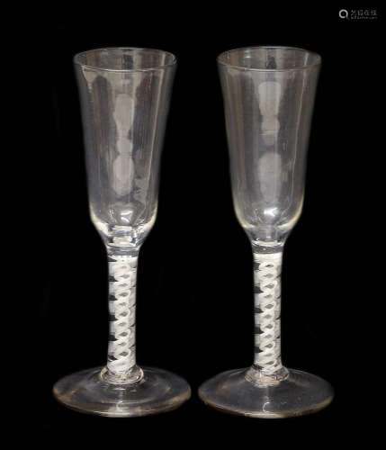 A Near Pair of Ale Flutes, circa 1755, the ogee bowls on opa...