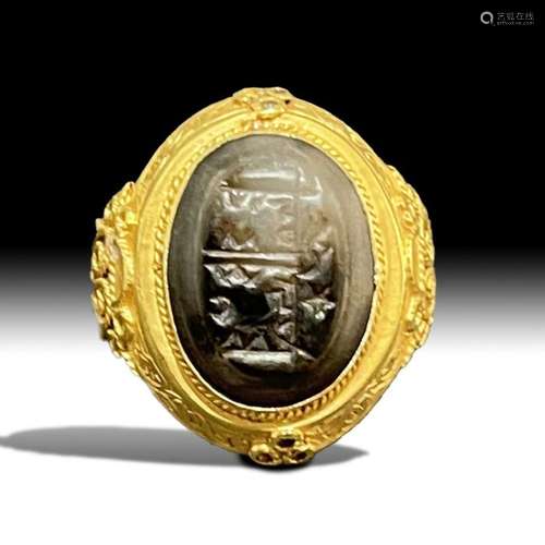 A GOLD ISLAMIC RING WITH AN INSCRIBED SEAL IN THE STYLE OF S...