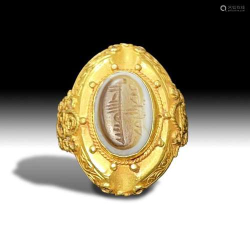 A GOLD ISLAMIC RING WITH AN INSCRIBED SEAL IN THE STYLE OF S...