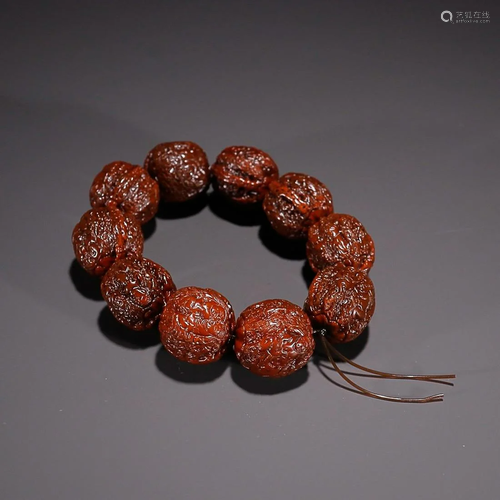 CHINESE WALNUT BEADED BRACELET WITH CARVED 'FIGURE STOR...