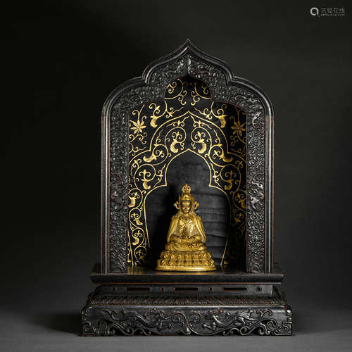 A lacquer lacquer shrine with a gilt bronze seated Buddha st...